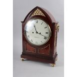 A Regency mahogany arch-top cased mantel clock by Grayson of Henley with hour repeat and striking