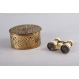 A pierced brass pot pourri box and cover and a pair of ivory cased opera glasses (splits)