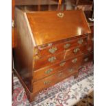 A late Georgian mahogany fall front bureau with fitted interior over one long, two short and two