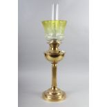 A Victorian brass oil lamp with reeded column and engraved yellow glass shade