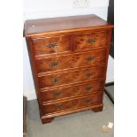 A burr elm chest of two short and four long drawers, on bracket supports, 24" wide