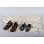 A 1930s lace and white metal mounted shawl, a pair of infant's leather shoes and a pair of child's