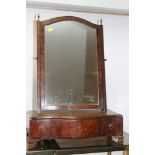 A George III mahogany and banded swing frame toilet mirror, on serpentine front plateau base, fitted