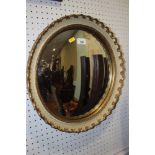 A gilt framed convex wall mirror with cream cross-hatched decoration, plate 13" dia