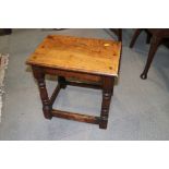 An oak joint stool of 17th century design, on turned and stretchered supports, 17 3/4" wide x 11 1/