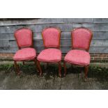 Three walnut framed salon chairs, upholstered in a pink brocade