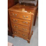 A mahogany chest of four long drawers with brass handles, on bracket feet, 17 1/2" wide x 12 1/2"