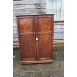 A chemist's 19th century cupboard with finely adjustable shelving enclosed two panelled doors, 40"