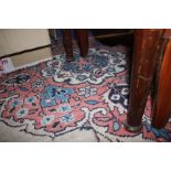 A Persian design carpet with central floral medallion on a buff ground and multi-borders in shades