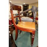 A set of six early 19th century mahogany standard dining chairs with bar backs and leather drop-in