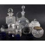 A cut glass decanter and stopper, glass preserve jars and cover, two silver mounted toilet jars