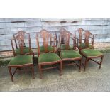 A set of eight mahogany dining chairs of Hepplewhite design with pierced splat and humpbacks with