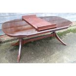 A mahogany shape top extending dining table with one extra leaf, and sideboard to match