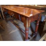 A sheesham side table, fitted two drawers, on turned and stretchered supports, 57" wide x 15 1/2"