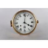 A Sewills brass cased bulkhead clock with white enamel dial and Roman numerals, 7 1/4" dia overall