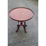 A mahogany and banded oval tray top wine table, 19" wide x 16" deep x 21" high, a mahogany shape top