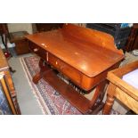 A late Victorian mahogany ledge back washstand, fitted two drawers and undertier, on pierced panel