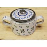 An 18th century Delft ware two handled posset pot and associated cover with white metal mounts, 8