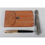 A leather cigar case with silver mount, a white metal scabbard with embossed decoration, 5 1/4"