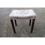 A George VI coronation stool, now reupholstered in a floral fabric, on square chamfered supports,