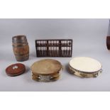 Two tambourines, a wooden abacus, 14 1/2" wide, a barrel, 9 1/2" high and a vintage tape measure