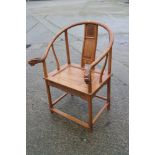 A Chinese carved oak armchair with dragon head terminals and panel seat, 27" wide x 25" deep x 39