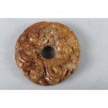 A Chinese carved brown jade pi disc, 2 1/4" dia