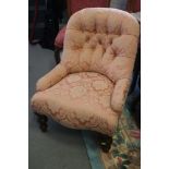 A tub shape occasional chair, button upholstered in a floral pink brocade, on turned supports