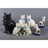 A black glazed model of a cat, 13" high, and three other pairs of model cats