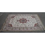 A Kashmir carpet with floral medallions on a gold ground, 90" x 62" approx