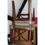 A pair of early 19th century mahogany 'X' back dining chairs with stuffed over seats, on turned