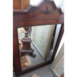 A mahogany framed rectangular overmantel mirror with shaped top and turned finials, 23 3/4" x 19"