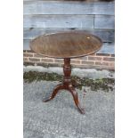 A George III Cuban mahogany circular tilt top occasional table, on vase turned column, acanthus