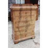 A 19th century Continental figured mahogany chest of frieze drawer over four long drawers and