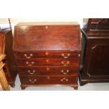 A late Georgian mahogany fall front bureau, the fitted interior over four long graduated drawers