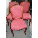 Three walnut framed salon chairs, upholstered in a pink brocade, on cabriole supports, a spoon