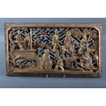 A Chinese carved giltwood bed panel of a landscape with figures, 16 3/4" wide