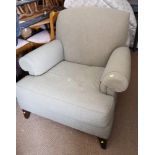 An Edwardian deep-seat armchair with down loose seat cushion, upholstered in a green figured fabric,