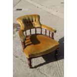An oak framed tub chair, upholstered in an ochre velour, on turned supports, and a child's 1920s low