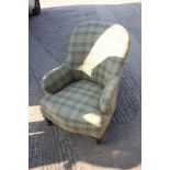 A tub seat armchair, upholstered in a tartan fabric, on turned supports