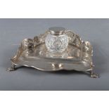 A silver desk stand with pierced gallery and cut glass inkwell with silver lid