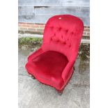 A tub shape occasional chair, button upholstered in a red Dralon, on turned supports