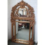 A 17th century design carved giltwood wall mirror, plate 25 1/4" x 19", 58" high overall