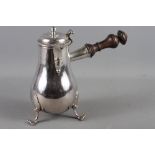 An 18th century French silver chocolate pot with turned ebonised handle and dragon armorial, maker's