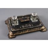 A papier-mache inkstand with mother-of-pearl insets and gilt borders