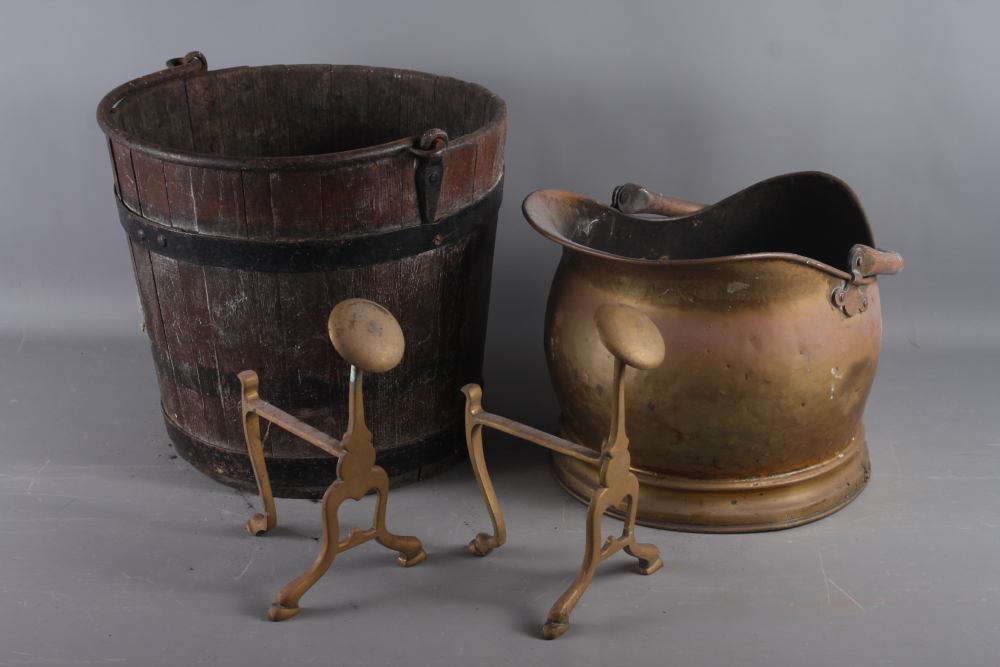 A coopered oak coal bucket, a copper coal helmet and a pair of brass andirons