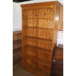 A pine open bookcase, fitted six shelves, on block base, 38" wide x 11" deep x 75" high