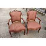 A pair of Louis XVI design carved walnut showframe open armchairs, upholstered in a green and red