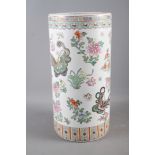 A Chinese ceramic stick stand with insect and flower decoration, 18" high
