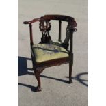 A George III carved mahogany corner elbow chair with pierces splats and drop-in needlework seat,